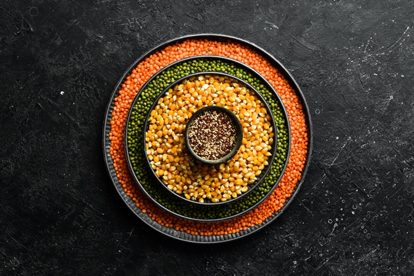 assortment of legumes lentils chickpeas and beans rice in different bowls on a stone table top view healthy food - Овощи, бобовые, грибы: полезные советы