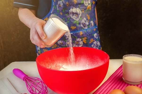 baking ingredients and utensils for cooking sponge cake process cooking sponge cake woman adds sugar in the dough - Праздничный агнец из дрожжевого теста