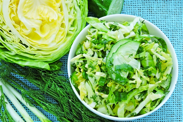 fresh green vegetarian salad with young cabbage cucumber greens - Салат из молодой капусты
