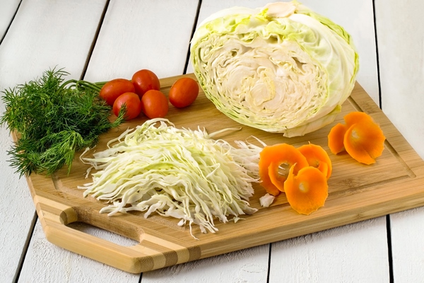fresh vegetables prepared for a vegetable soup on a cutting board and a white wooden background - Постный борщ с фасолью