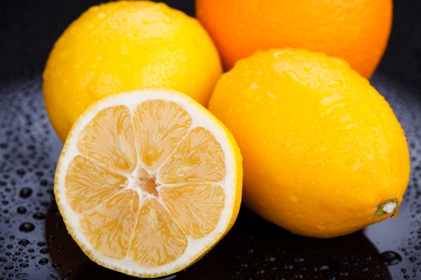 juicy delicious oranges and lemons on wet table - Фрукты, ягоды