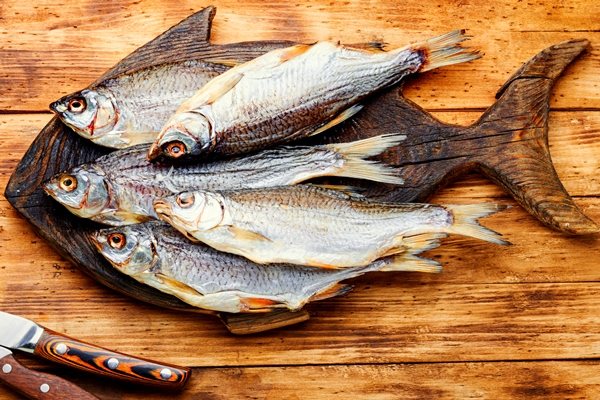 sun dried fish salted fish for beer on old wooden table - Как правильно обрабатывать и готовить рыбу?