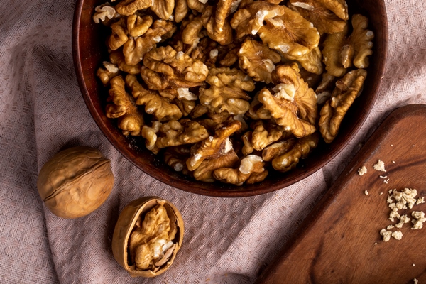 top view of walnuts in a bowl on a tablecloth - Сочиво
