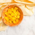 top view pieces of pineapple in bowl - Салат слоёный с ананасом