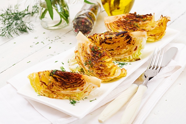 vegan grilled cabbage steaks white wooden table - Капуста в хлебных крошках