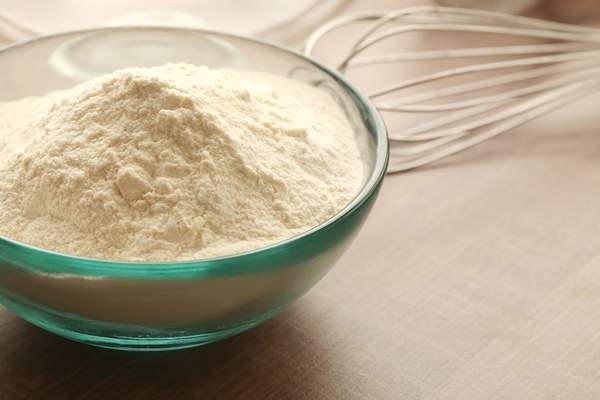 bowl with flour and ingredients for dough on table - Постные пресные блины на картофельном отваре