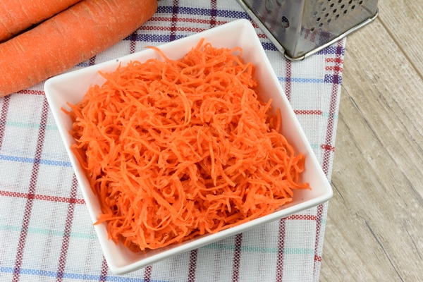 concept of preparing a healthy salad grated carrot in a white platter 1 - Салат из баклажанов с фасолью на зиму