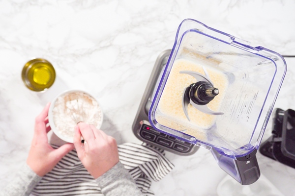 flat lay mixing ingredient in an electric blender to make the crepes batter - Постные пшённые блины с "льняным яйцом"