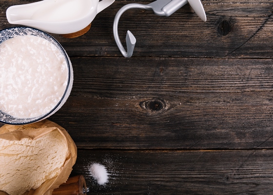 flour milk yeast and peppermill on table - Баба с ромом