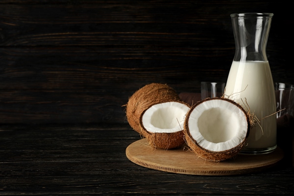 fresh coconut and coconut milk on wooden background - Постные блинчики на кокосовом молоке
