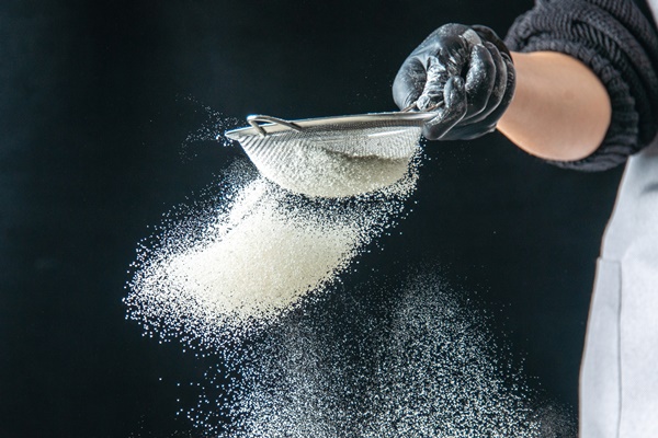 front view female cook pouring white flour into the pan on a dark egg job bakery hotcake pastry kitchen cuisine dough - Постные блинчики с какао