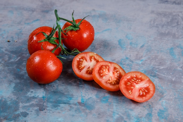 high angle view tomatoes with slices on textured surface horizontal - Грибы в томате