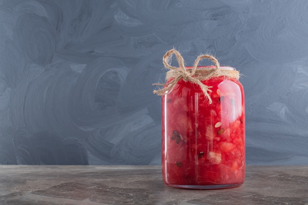 jar of juice watermelon on marble - Маринованные арбузы