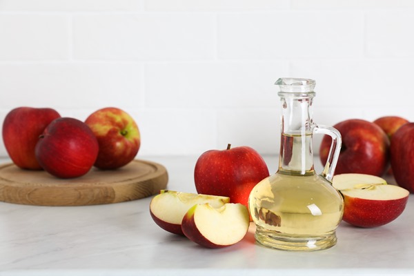 natural apple vinegar and fresh fruits on white marble table space for - Маринованные опята