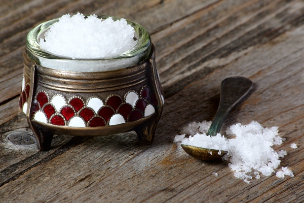 nutritional salt in an old salt cellar on a gray wooden table - Блины пшенично-ржаные постные