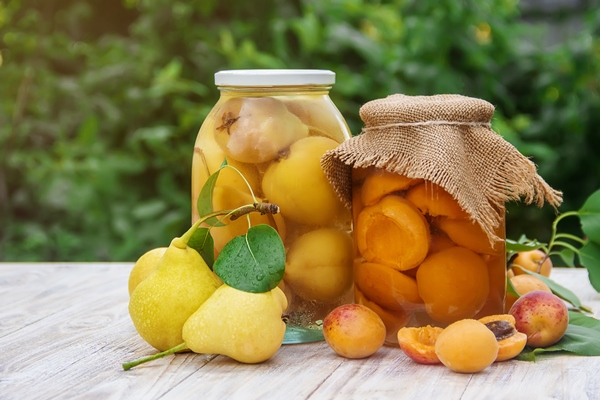 preserved house pears apricots and jam with blackberries in jars selective focus 1 - Консервированные яблоки