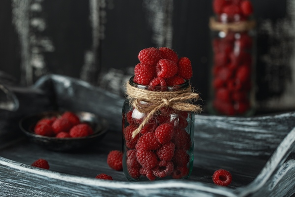 raspberry in a glass jar on dark wooden table healthy food concept fresh organic berries - Малина в собственном соку