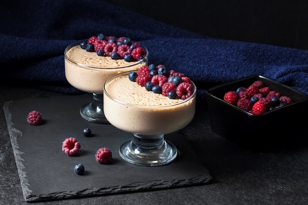 ryazhenka fermented baked milk mousse in glass bowls decorated with fresh berries - Домашняя ряженка по-деревенски