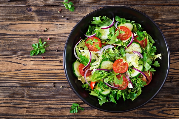 salad from tomatoes cucumber red onions and lettuce leaves healthy summer vitamin menu vegan vegetable food vegetarian dinner table top view flat lay - Постные блины на фасолевом отваре
