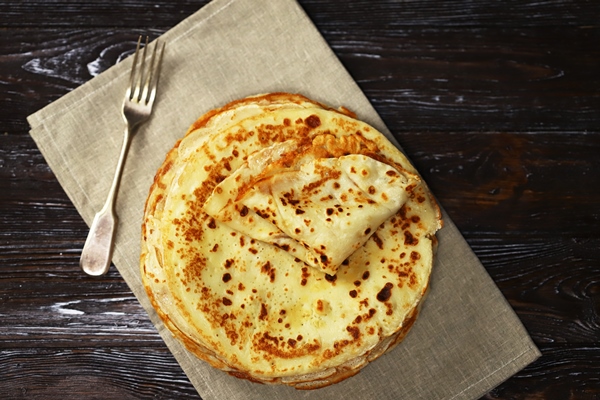 selective focus a stack of pancakes on a platter 1 - Постные блинчики с рисом и изюмом