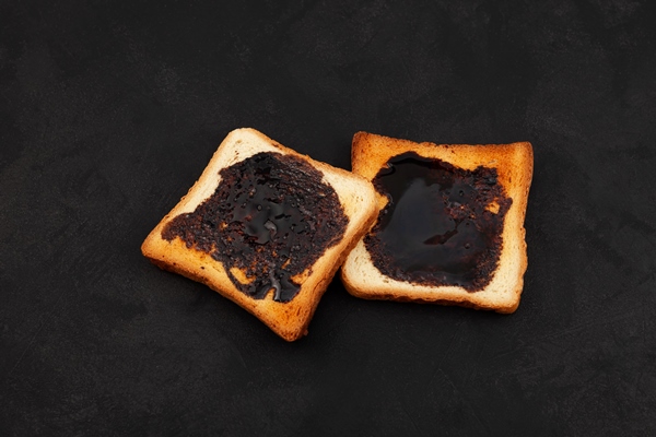 wheat crispy toast with brown spread top view toasted slices of bread for breakfast - Гренки с мармеладом из чернослива на гриле