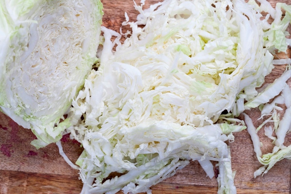 white cabbage cut into pieces cabbage sliced and chopped for cooking - Постные капустные блинчики со шпинатом