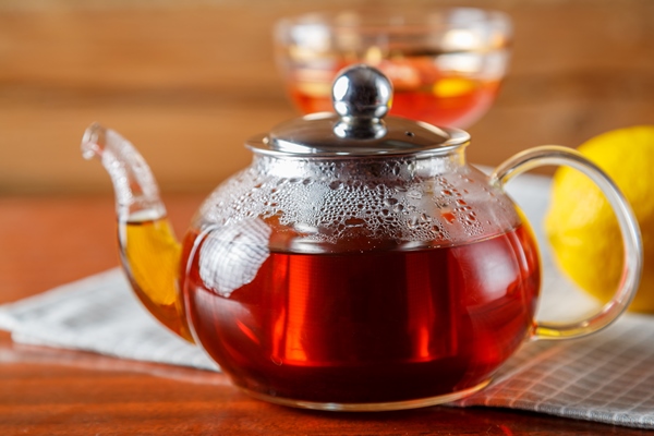 a teapot of strong hot tea on the table on a napkin - Торт постный