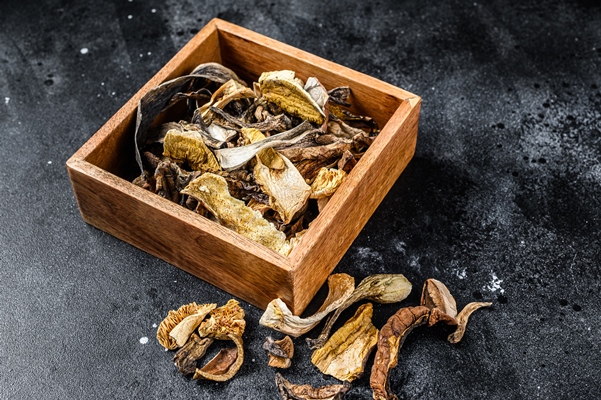 boletus wild dried mushrooms in a wooden - Свекольная икра с грибами