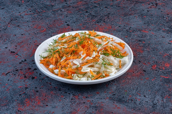 cabbage and carrot salad on a platter on black table - Салат из моркови и капусты