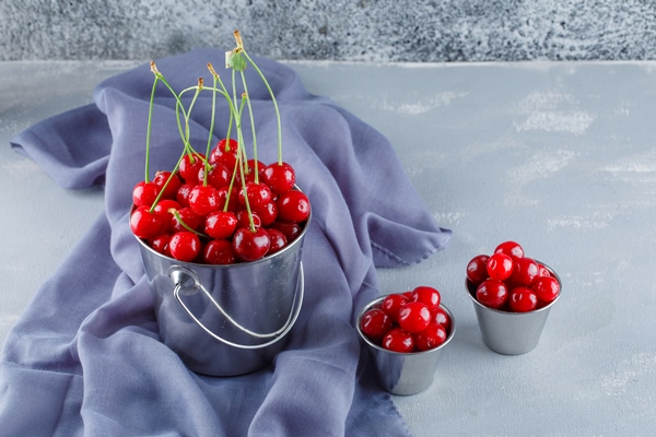 cherries with textile in buckets high angle view - Маседуан из вишен и груш