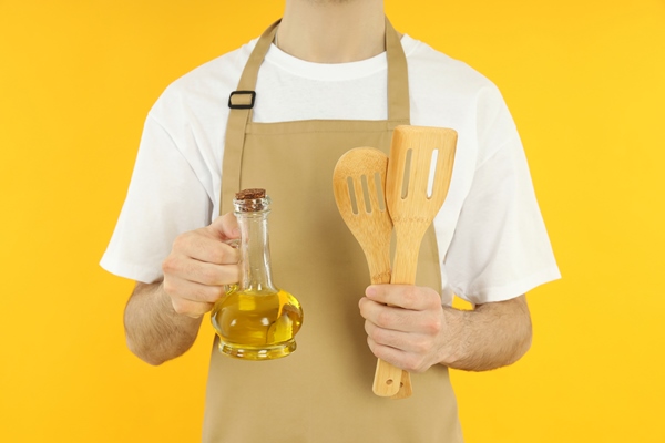 concept of cooking young man in apron on yellow background - Постное тесто для сладких пирогов