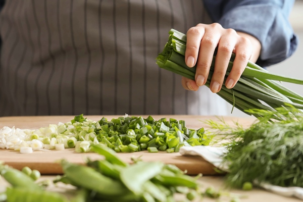 cooking chef is cutting greens in the kitchen - Салат "Осенний"