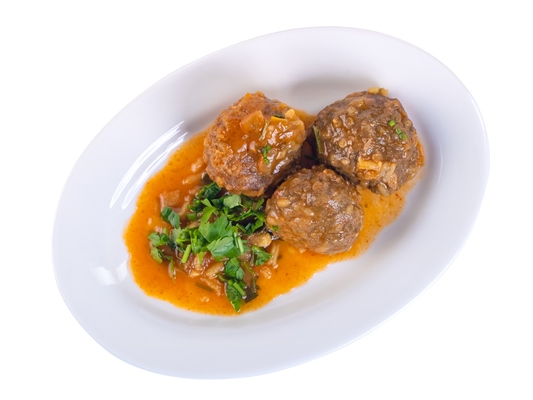 delicious swedish meatballs with a hearty brown sauce with parsley on the white plate isolated on white - Подливка овощная постная