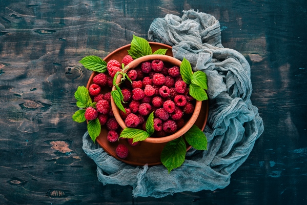 fresh raspberry berries in a wooden plate on a wooden background top view free space for your - Малиновый морс