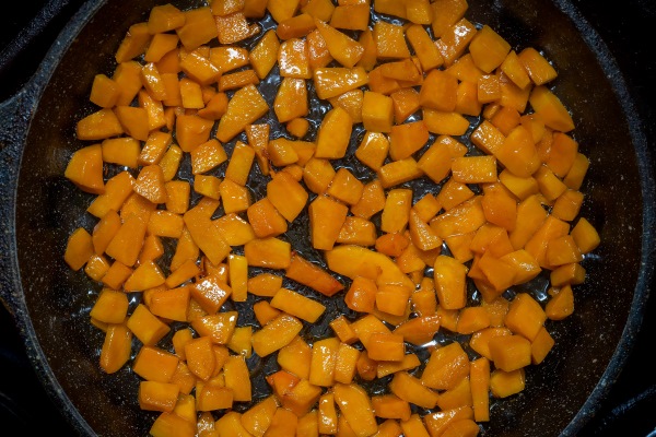 fried pumpkin cut into bars on a cast iron pan top view close up - Тыква жареная, постный стол