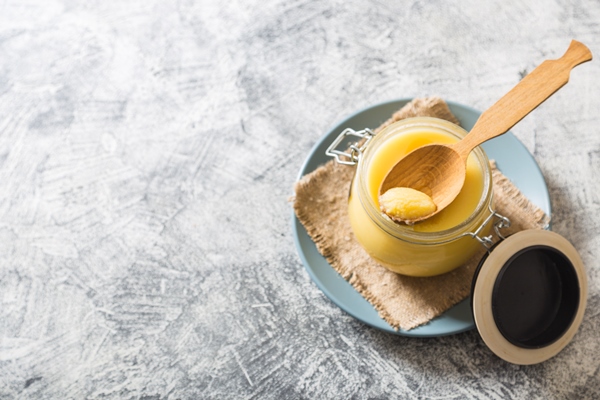 ghee or clarified butter in jar and wooden spoon on gray table top view copyspace ghee butter have healthy fat and is a common cooking ingredient in many of the indian food 2 - Суп из сныти с овсянкой