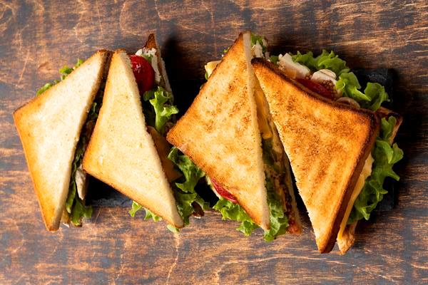 high angle of triangle sandwiches with tomatoes - Горячий сэндвич с сыром и зеленью