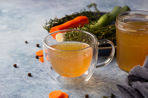 homemade bone broth in glass mug and vegetables collagen source for the body - Суп грибной с рисом, постный стол