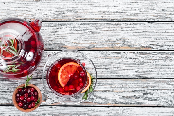 hot drink of cranberry and orange in cups on a white wooden background top view free space for your - Клюквенный чай