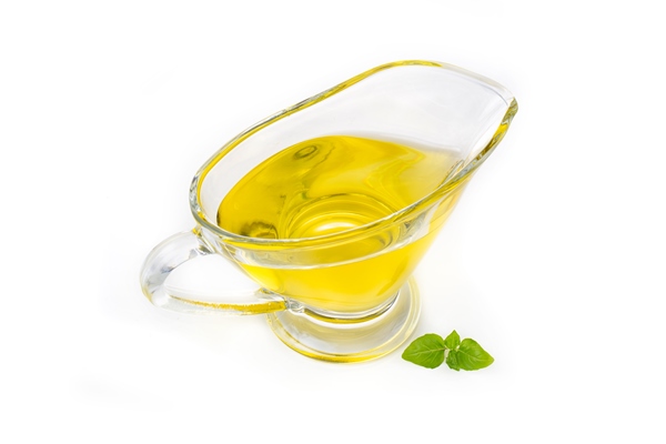 olive or sunflower yellow oil in a glass saucepan isolated on a white background - Праздничная коврижка