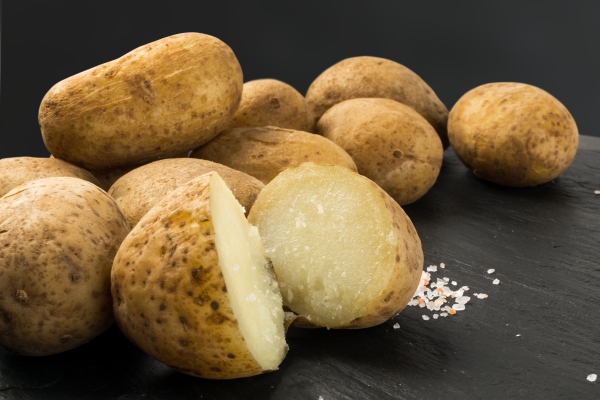potatoes boiled in their skins on stone background - Постная картофельная запеканка с грибами и зеленью