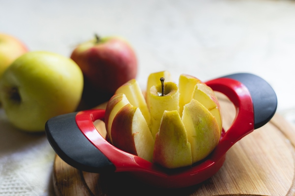 round apple slicer on a board making eight segments for breakfast - Тушёные яблоки к жареной рыбе