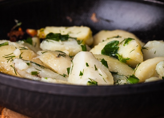 rustic baked potato with herbs in frying pan - Картофель с орехами и гранатом