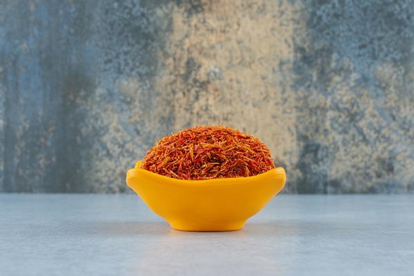 saffron spices in a yellow ceramic cup on blue background high quality photo - Постный именинный крендель
