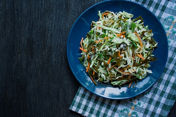 salad of white cabbage sea kale and fresh carrots seasoned with olive oil - Салат из морской капусты
