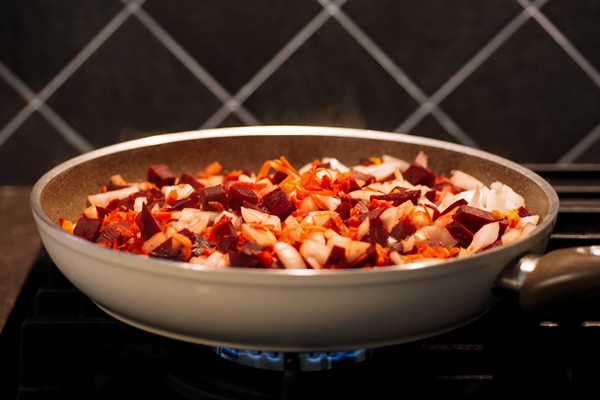 sliced carrots onion and beets in a pan on a dark background cooking borsch dressing - Овощное постное рагу