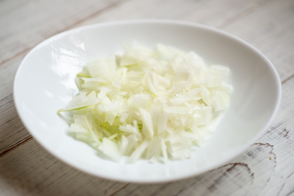 sliced onions on a white plate preparation of ingredients for cooking - Соус Тартар