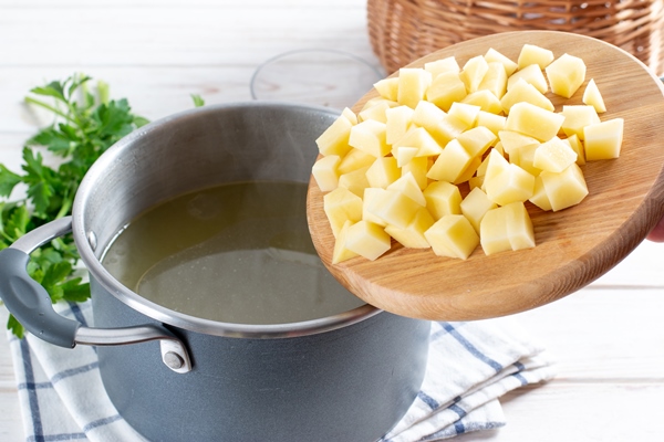 step by step preparation soup with pumpkin and vegetables step adding chopped potatoes to the broth - Суп с корневищами иван-чая