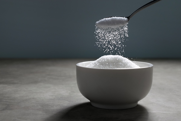 sugar being poured from spoon into a bowl empty ready for your product display or montage - Оладьи тыквенные