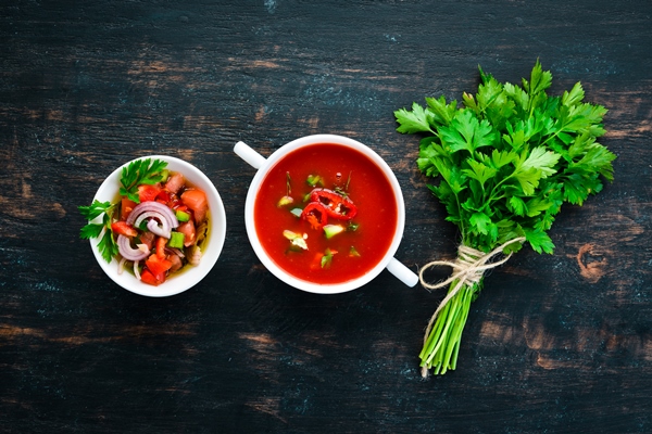 tomato soup with onion cucumber and paprika top view on a black background free space for - Салат из перца с яблоком